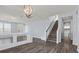 Open concept living room with hardwood floors, staircase and a view to the front door at 6540 W Cougar Ave, Las Vegas, NV 89139