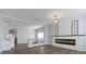 Modern living room with hardwood floors, updated fireplace and two windows with natural light at 6540 W Cougar Ave, Las Vegas, NV 89139