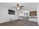 Spacious living room with plank flooring, ceiling fan and accent wall at 6540 W Cougar Ave, Las Vegas, NV 89139