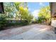 Spacious backyard featuring a brick-paved patio, mature trees, and ample room for outdoor living at 6608 Burgundy Way, Las Vegas, NV 89107