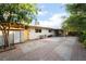 This backyard features a brick patio, storage shed, and mature trees offering shade and privacy at 6608 Burgundy Way, Las Vegas, NV 89107