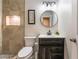 Bathroom boasts updated vanity, framed round mirror, and tiled shower with mosaic tile niche at 6608 Burgundy Way, Las Vegas, NV 89107