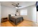 Neutral bedroom with ceiling fan and wood-look tile flooring at 6608 Burgundy Way, Las Vegas, NV 89107