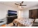 Spacious bedroom with a ceiling fan and natural light, showcasing comfortable living at 6608 Burgundy Way, Las Vegas, NV 89107