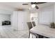 Bright dining area with white tile floors and view into another room with a piano at 6608 Burgundy Way, Las Vegas, NV 89107
