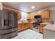 Spacious kitchen featuring stainless steel appliances, tile floors and light wood cabinets at 6608 Burgundy Way, Las Vegas, NV 89107
