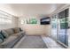 Cozy living room featuring sliding glass doors, a comfortable couch, and modern decor at 6608 Burgundy Way, Las Vegas, NV 89107
