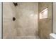 Tiled shower features mosaic tile accents and a sleek shower head in remodeled bathroom at 6608 Burgundy Way, Las Vegas, NV 89107