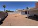 The backyard features desert landscaping and a covered patio at 6929 Montcliff Ave, Las Vegas, NV 89147