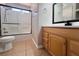 Bright bathroom featuring a tiled shower-tub combo, modern fixtures, and a wood vanity at 6929 Montcliff Ave, Las Vegas, NV 89147