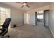 Spacious bedroom featuring carpet, mirrored closet doors, and ceiling fan at 6929 Montcliff Ave, Las Vegas, NV 89147