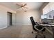 Bedroom featuring carpet, a ceiling fan, closet with mirrored doors and a workstation at 6929 Montcliff Ave, Las Vegas, NV 89147