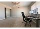 Bedroom featuring carpet, a ceiling fan, closet with mirrored doors and a workstation at 6929 Montcliff Ave, Las Vegas, NV 89147