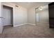 Bedroom features carpet, mirrored closet doors, and exterior and interior door access at 6929 Montcliff Ave, Las Vegas, NV 89147