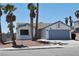Inviting single-story home with desert landscaping, swaying palm trees, and a welcoming two-car garage at 6929 Montcliff Ave, Las Vegas, NV 89147