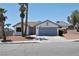 Charming single-story home featuring desert landscaping, palm trees, and a two-car garage at 6929 Montcliff Ave, Las Vegas, NV 89147