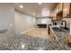 Kitchen showcasing granite countertops and a stainless steel sink, with ample natural light at 6929 Montcliff Ave, Las Vegas, NV 89147