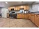 The kitchen features stainless steel appliances, granite countertops and tile flooring at 6929 Montcliff Ave, Las Vegas, NV 89147