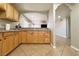 Open kitchen with granite countertops and light wood cabinets, seamlessly flowing into the living area at 6929 Montcliff Ave, Las Vegas, NV 89147