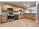 The kitchen features stainless steel appliances, granite countertops and tile flooring at 6929 Montcliff Ave, Las Vegas, NV 89147