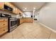 The kitchen features stainless steel appliances, granite countertops and tile flooring at 6929 Montcliff Ave, Las Vegas, NV 89147