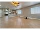 Spacious living room with tile flooring, ceiling fan, and kitchen view through decorative partition at 6929 Montcliff Ave, Las Vegas, NV 89147