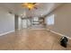 Bright, open living room with tile flooring, ceiling fan, and convenient access to the kitchen area at 6929 Montcliff Ave, Las Vegas, NV 89147
