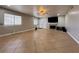 Bright and airy living room with tile flooring, featuring a fireplace and access to the patio at 6929 Montcliff Ave, Las Vegas, NV 89147