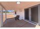 View of the backyard patio area with seating and glass doors to the home at 6929 Montcliff Ave, Las Vegas, NV 89147