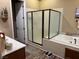 Modern bathroom with a stand-alone shower and a large soaking tub at 7524 Midnight Rambler St, Las Vegas, NV 89149