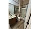 The bathroom features a shower with a glass door, wood cabinets, and a framed mirror at 7524 Midnight Rambler St, Las Vegas, NV 89149