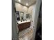 Bathroom featuring double sinks, wooden cabinets, and a large mirror at 7524 Midnight Rambler St, Las Vegas, NV 89149