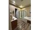Bathroom featuring a shower and soaking tub with a brown vanity and wood-look flooring at 7524 Midnight Rambler St, Las Vegas, NV 89149