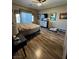 Bedroom featuring a ceiling fan, decorative art, wood flooring, and plenty of natural light at 7524 Midnight Rambler St, Las Vegas, NV 89149