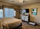 Bedroom featuring a ceiling fan, natural light, wood flooring, and decorative art on the walls at 7524 Midnight Rambler St, Las Vegas, NV 89149