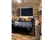 Comfortable bedroom with dark blue bedding and a collection of sports-themed decorations at 7524 Midnight Rambler St, Las Vegas, NV 89149