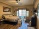 Comfortable bedroom featuring natural light, a ceiling fan, and wood flooring at 7524 Midnight Rambler St, Las Vegas, NV 89149