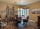 Charming dining room with stylish decor, chandelier, bay window, wood floors, and ample natural light at 7524 Midnight Rambler St, Las Vegas, NV 89149
