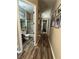 Hallway with Gathering photos leading to a bathroom, showcasing the home's layout at 7524 Midnight Rambler St, Las Vegas, NV 89149