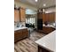 Well-equipped kitchen featuring wooden cabinets, hardwood floors, granite countertops and stainless appliances at 7524 Midnight Rambler St, Las Vegas, NV 89149