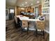 Bright kitchen with a large island, stylish chairs, and wooden cabinets at 7524 Midnight Rambler St, Las Vegas, NV 89149