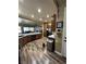 Well-lit kitchen with wood cabinets, stainless steel appliances, and hardwood floors at 7524 Midnight Rambler St, Las Vegas, NV 89149