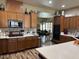 Spacious kitchen with wood cabinets, granite countertops, and stainless steel appliances at 7524 Midnight Rambler St, Las Vegas, NV 89149
