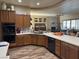 Spacious kitchen with wooden cabinets, large island, and stainless steel appliances at 7524 Midnight Rambler St, Las Vegas, NV 89149