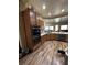 Well-equipped kitchen featuring wooden cabinets, hardwood floors and stainless steel appliances at 7524 Midnight Rambler St, Las Vegas, NV 89149