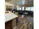 Expansive living room boasting wood floors, fireplace, pool table, comfortable seating and seamless flow to the kitchen at 7524 Midnight Rambler St, Las Vegas, NV 89149