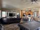 An expansive living room featuring a large leather sofa and an open layout with a kitchen at 7524 Midnight Rambler St, Las Vegas, NV 89149