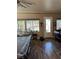 Well-lit living space with a pool table, window with blinds, and easy access to the front door at 7524 Midnight Rambler St, Las Vegas, NV 89149