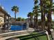 Backyard pool area featuring mature palm trees and a covered patio at 7524 Midnight Rambler St, Las Vegas, NV 89149