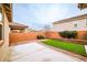 Low maintenance backyard featuring a patio area with artificial grass and desert landscaping at 766 Topocoba St, Las Vegas, NV 89178